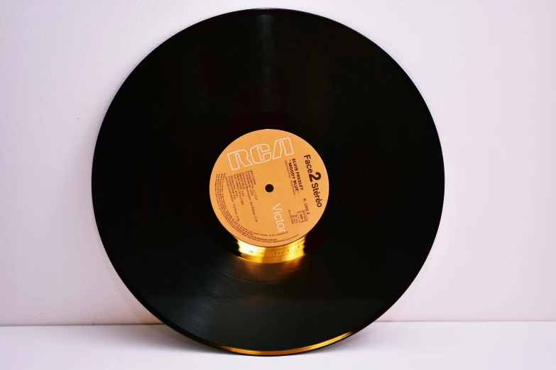 a black vinyl record sitting on top of a table