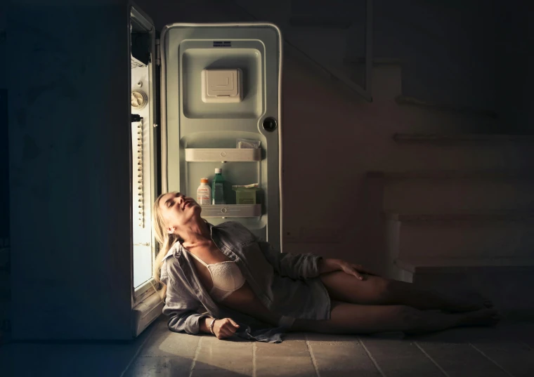 a woman laying on the floor in front of an open refrigerator, inspired by Elsa Bleda, pexels contest winner, hyperrealism, moonlight, miss aniela, sydney sweeney, sad man