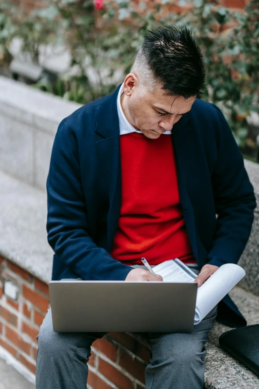 a man sitting on a ledge using a laptop, pexels contest winner, renaissance, wearing red formal attire, pen and paper, wearing a turtleneck and jacket, wearing business casual dress