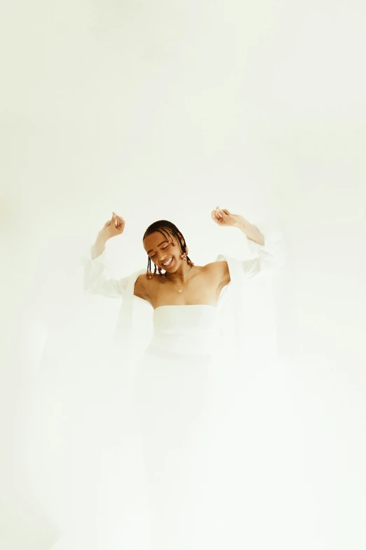 a woman in a white dress posing for a picture, an album cover, pexels contest winner, pose(arms up + happy), white backdrop, jemal shabazz, wearing a wedding dress