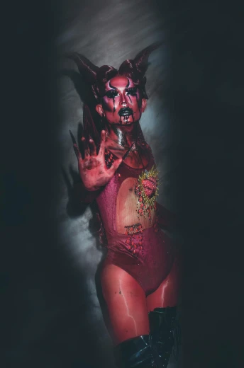 a woman in a devil costume posing for a photo, an album cover, transgressive art, covered in blood, arian mark, body paint, instagram photo