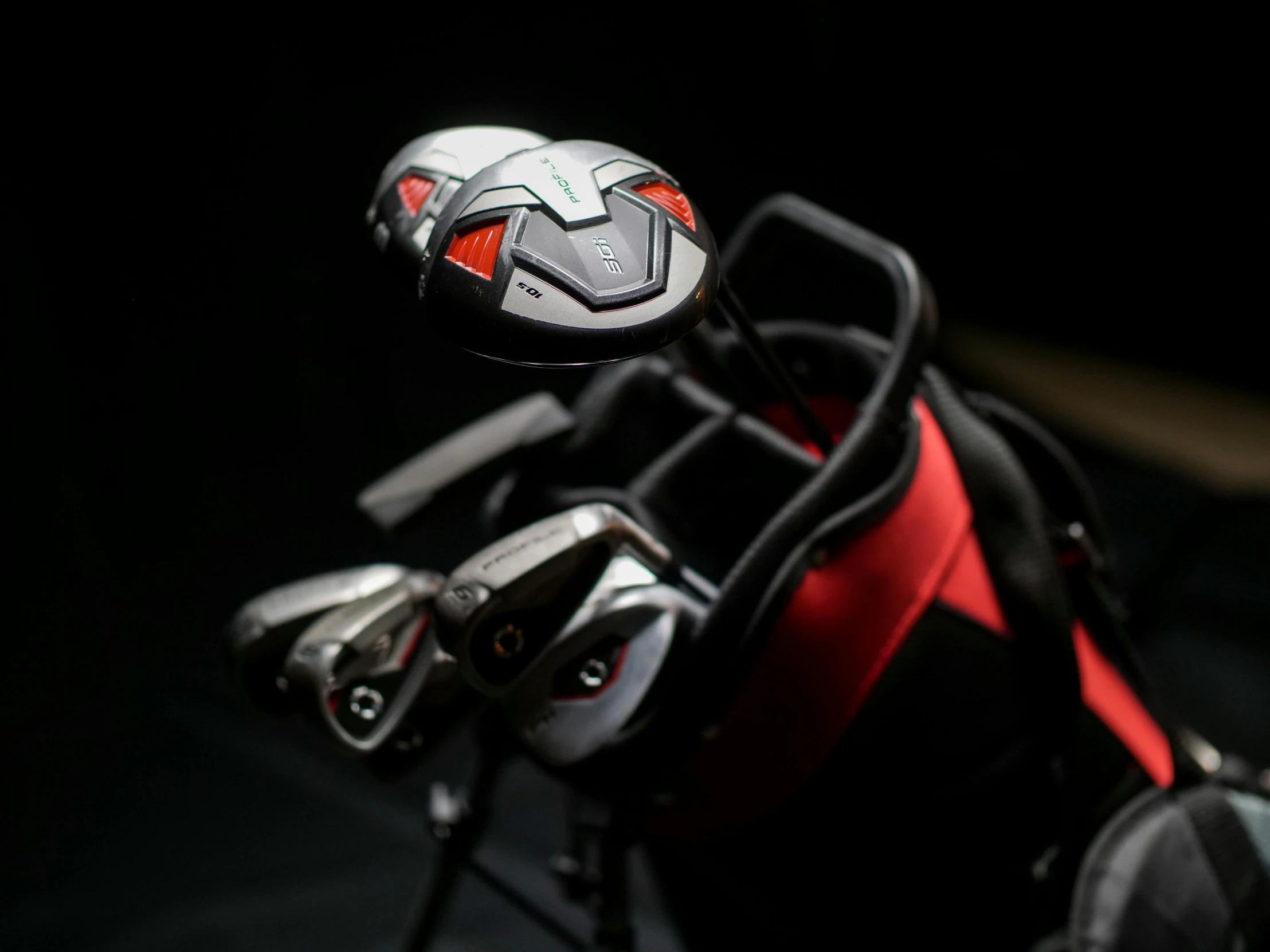 a close up of a bag of golf clubs, cg society contest winner, cobra, black and red reflected armor, substance designer metal, high tech saddle, product introduction photo