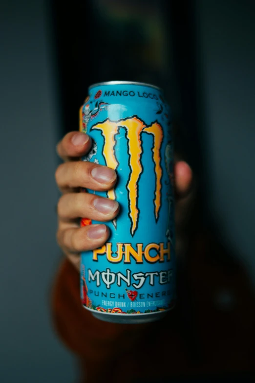 a person holding a can of monster punch, pexels, photographed for reuters, blue, mma, ah puch