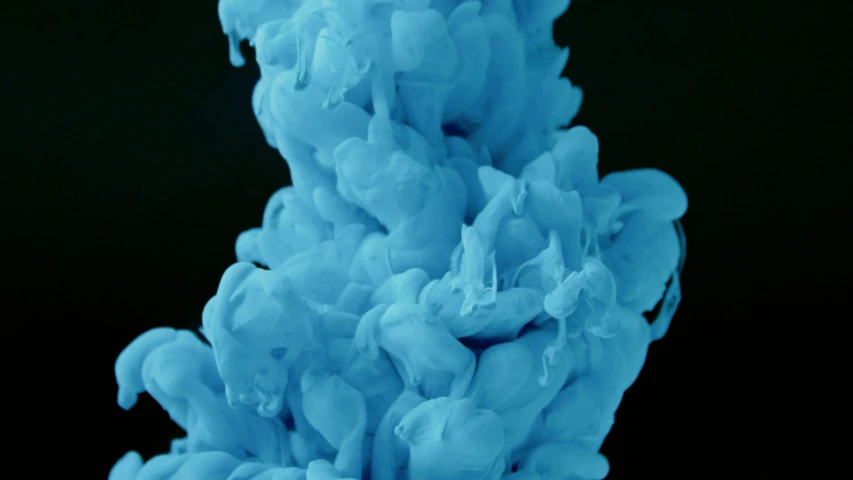 a close up of a blue substance on a black background, a microscopic photo, inspired by Kim Keever, unsplash, made of cotton candy, video still, hegre, vhs colour photography
