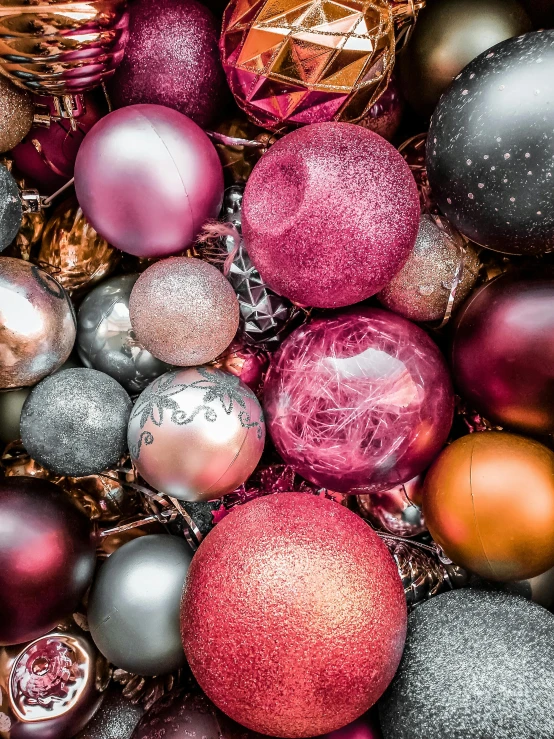 a pile of different colored christmas ornaments, by Adam Marczyński, pexels contest winner, magenta and gray, multiple stories, full frame image, cyber copper spiral decorations