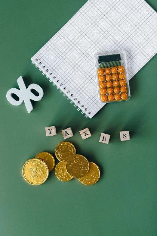 a calculator sitting on top of a desk next to a pile of coins, pexels contest winner, yellow and green scheme, flat lay, ta ha, icon