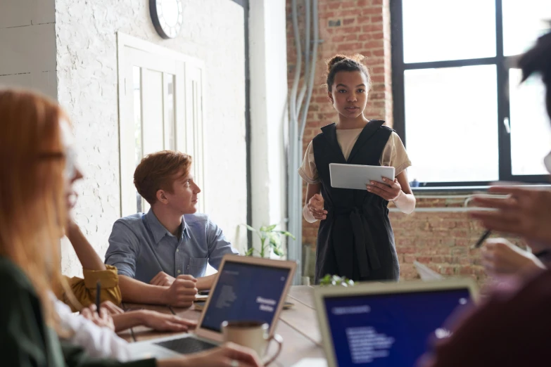 a woman giving a presentation to a group of people, pexels contest winner, renaissance, laptops, lachlan bailey, avatar image, female in office dress