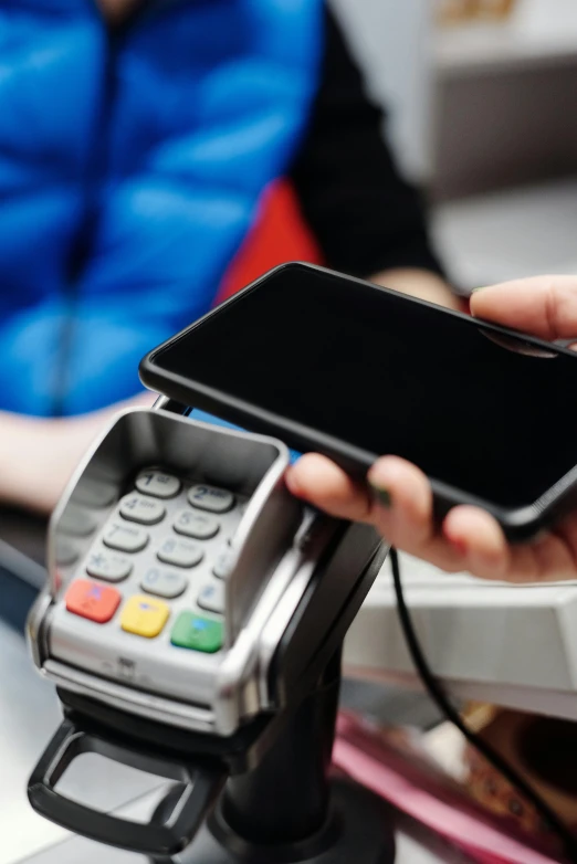 a person holding a smart phone in their hand, cash register, thumbnail, f / 2 0, —n 9