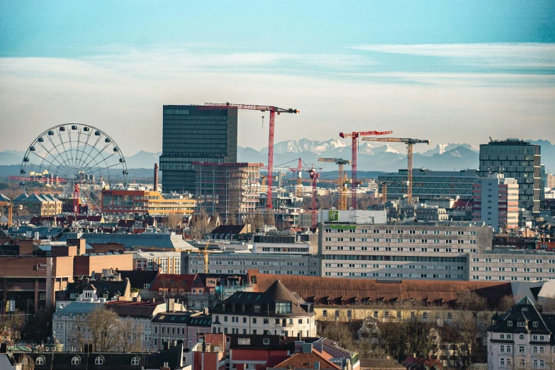 a view of a city with a ferris wheel in the background, pexels contest winner, viennese actionism, under construction, the alps are in the background, bjarke ingels, 70s photo
