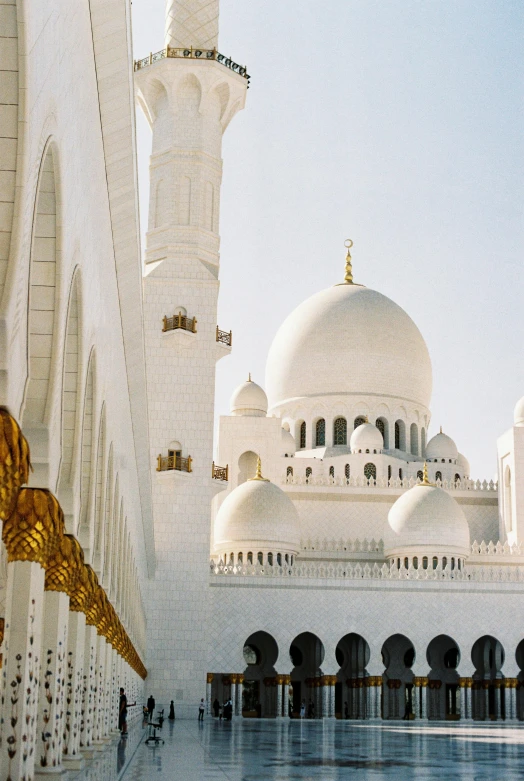 a large white building with a fountain in front of it, inspired by Sheikh Hamdullah, pexels contest winner, arabesque, domes, 1990s photograph, golden pillars, 1999 photograph