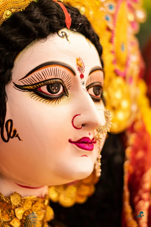 a close up of a statue of a woman, bengal school of art, super detailed face and eyes, a brightly colored, holy, drag
