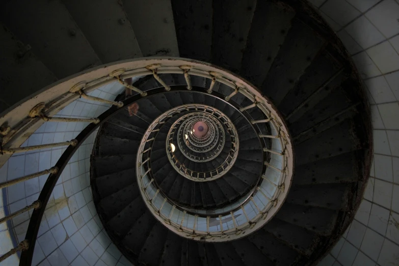 a spiral staircase leading to the top of a building, an album cover, by Adam Marczyński, unsplash contest winner, lighthouse, ignant, worm hole, looking down at you