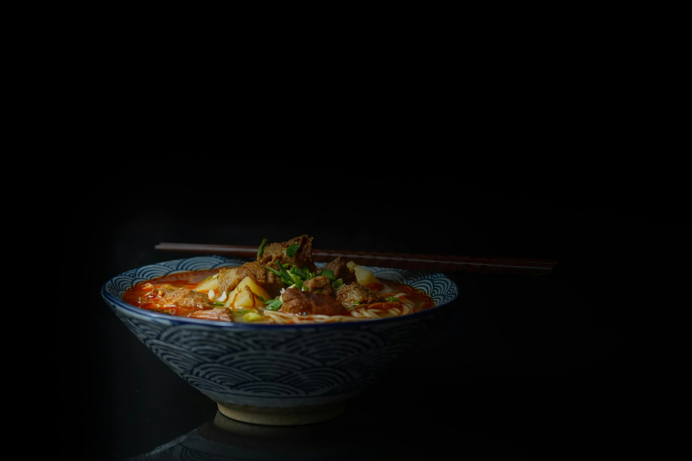 a close up of a bowl of food with chopsticks, fantastic realism, standing with a black background, portrait image, trending photo, shot on sony a 7