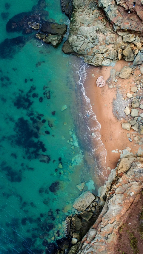 a bird's eye view of a sandy beach, by Daniel Taylor, pexels, crystal clear water, muted colours 8 k, rocky beach, 15081959 21121991 01012000 4k