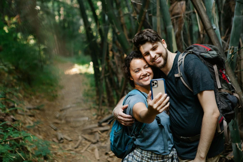 a man and woman taking a selfie in the woods, a picture, avatar image, hiking clothes, fan favorite, travel photography