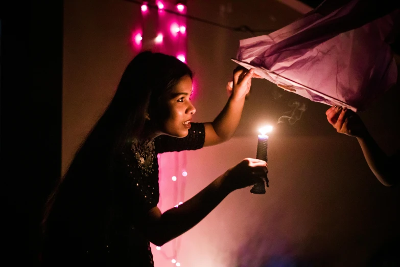 a woman holding a lit candle in her hand, by Daniel Lieske, pexels contest winner, assamese aesthetic, magenta lighting. fantasy, profile image, concert photo