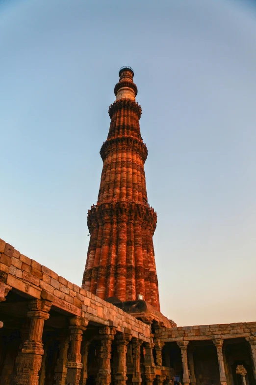 a tall tower sitting in the middle of a building, a statue, in the evening, ancient india, parks and monuments, chimneys