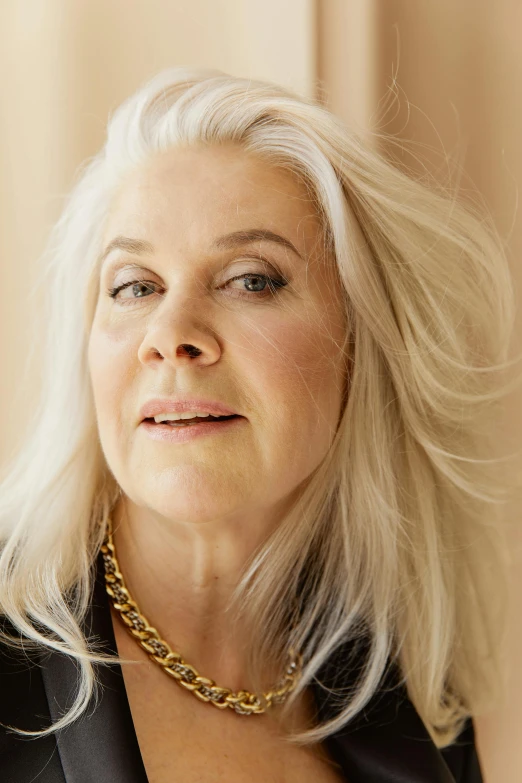 a woman with white hair wearing a black jacket, looking away from camera, pat mcgrath, janis rozentals, brown