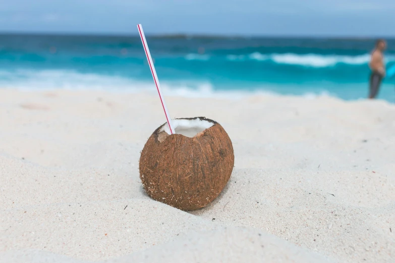 a coconut drink sitting on top of a sandy beach, unsplash, avatar image, high resolution, cornwall, contain