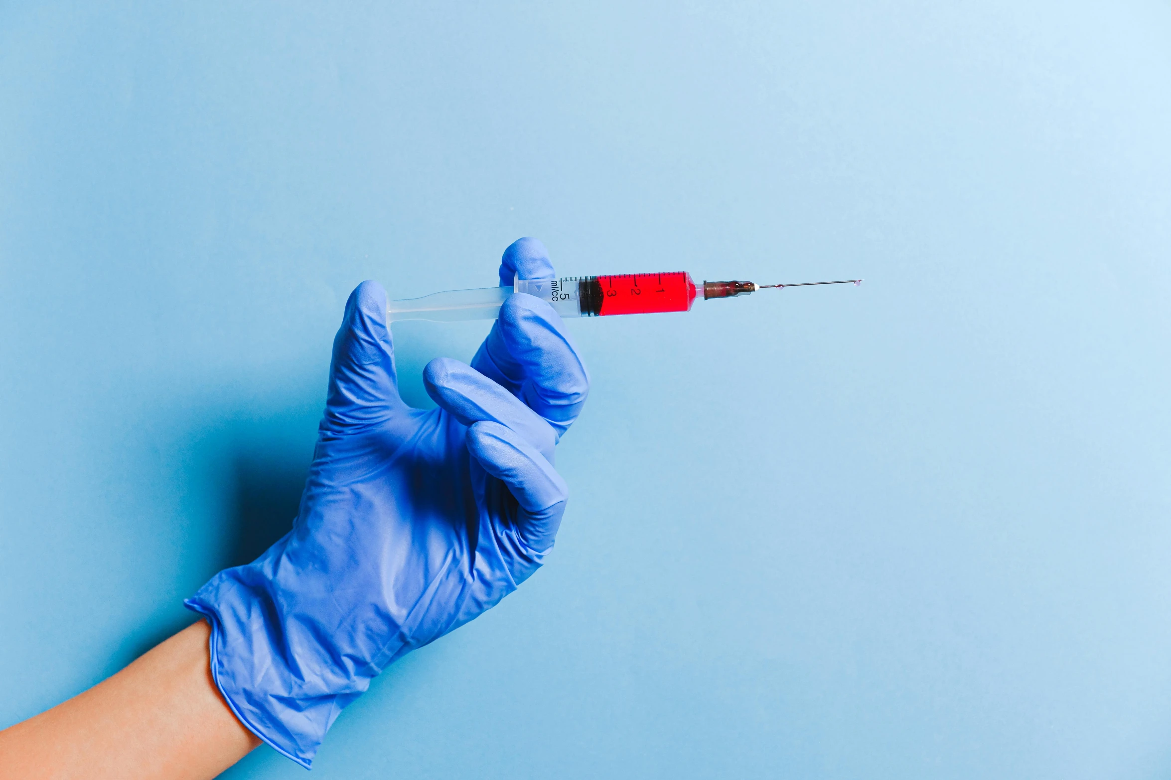 a person in blue gloves holding a syet, shutterstock, plasticien, syringe, instagram photo, 2000s photo, background image