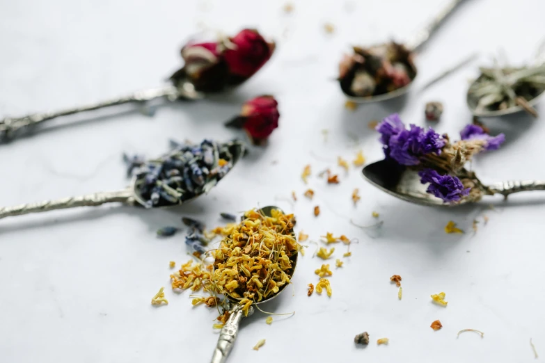 a group of spoons filled with dried flowers, by Jessie Algie, trending on unsplash, tea party, flowers inside of a marble, professional product photo, thumbnail