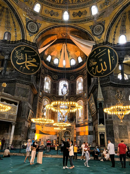 a group of people standing inside of a building, a mosaic, trending on unsplash, hurufiyya, with great domes and arches, demur, sultan, deity)