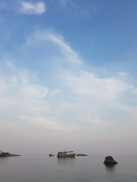 a boat floating on top of a body of water, inspired by Zhang Kechun, unsplash, big smoke clouds visible, cloudless-crear-sky, 6 : 3 0 am, today\'s featured photograph 4k