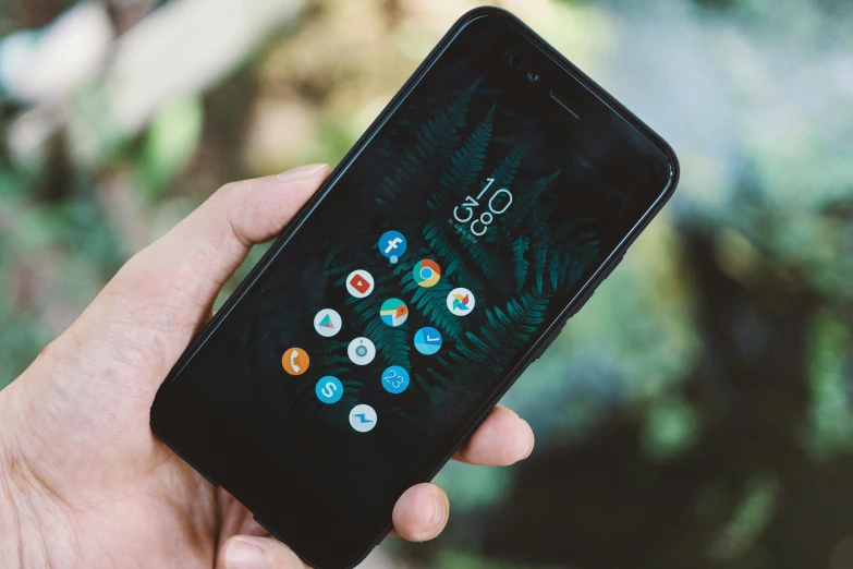 a close up of a person holding a cell phone, by Android Jones, pexels contest winner, icon pack, in front of a forest background, amoled wallpaper, rounded corners