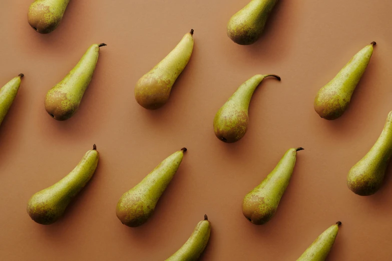 a group of pears sitting on top of a brown surface, trending on pexels, background image, frank moth, beans, 6 pack