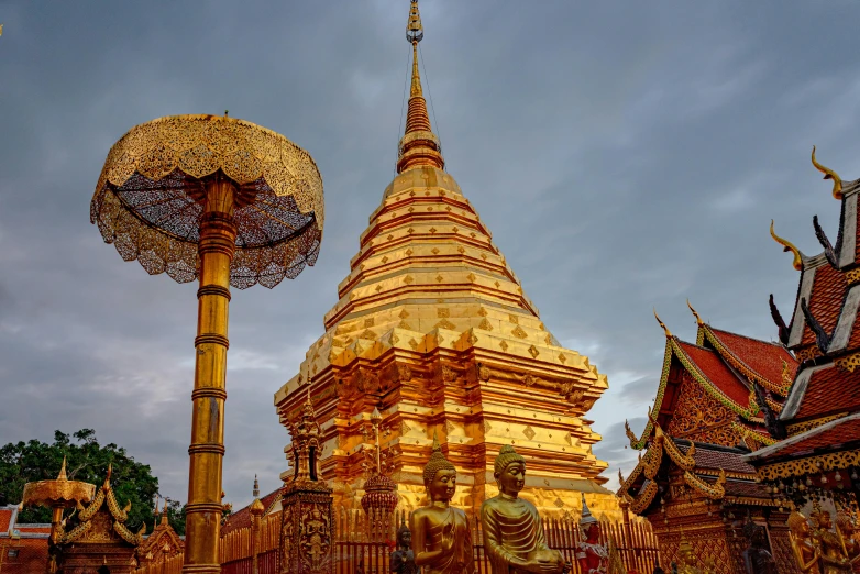 a golden pagoda with an umbrella in front of it, square, thumbnail, thawan duchanee, high-resolution photo