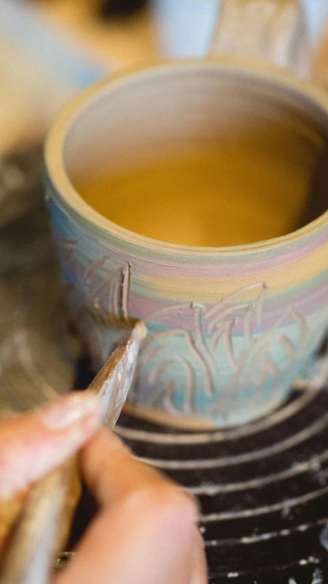 a close up of a person making a cup of tea, process art, made out of clay, beautiful opalescent colours, thumbnail, engraved