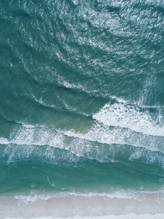 a large body of water next to a sandy beach, pexels contest winner, cresting waves and seafoam, aerial footage, today's featured photography 4k, manly