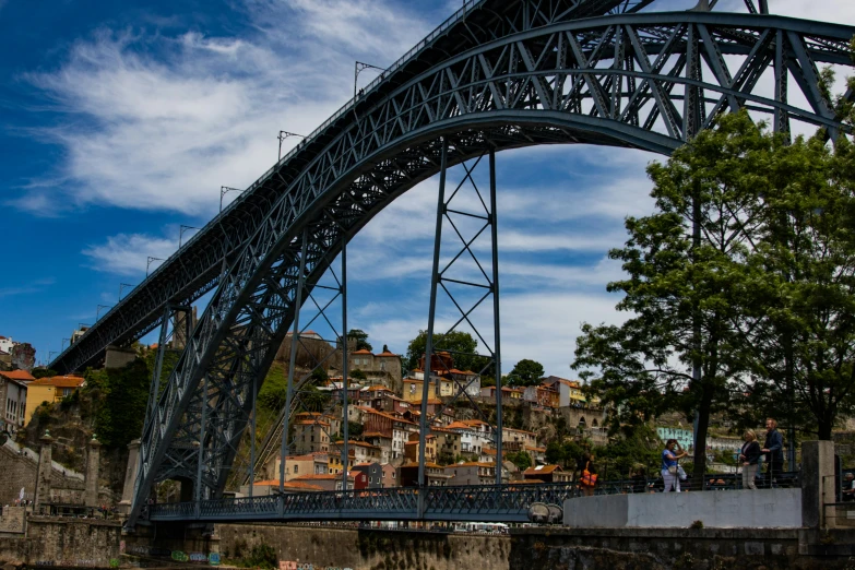 a bridge spanning over a body of water, pexels contest winner, art nouveau, gui guimaraes, steel archways, hillside, thumbnail