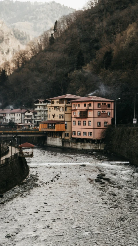 a train traveling down train tracks next to a river, inspired by Elsa Bleda, pexels contest winner, renaissance, nepali architecture buildings, bosnian, thumbnail, muted colors. ue 5