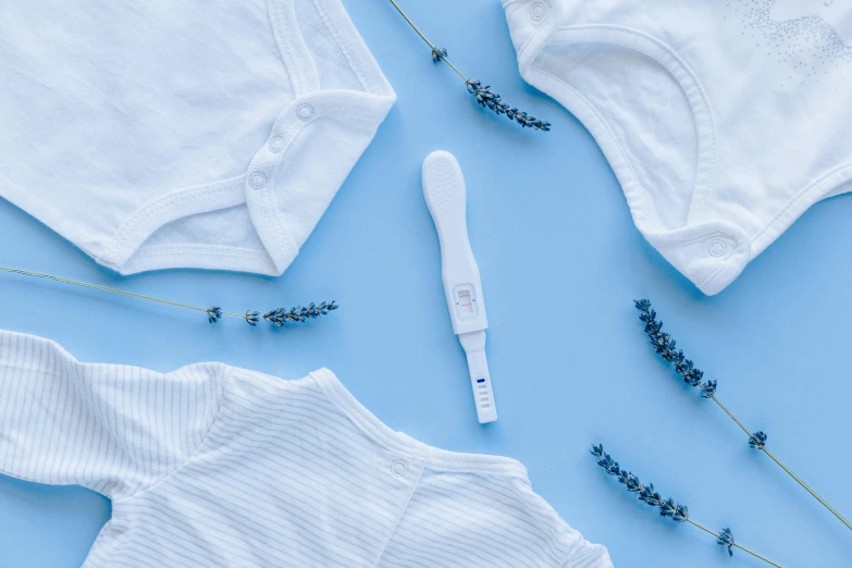 baby clothes and a thermometer on a blue background, trending on pexels, happening, wearing white cloths, verbena, close together, background image