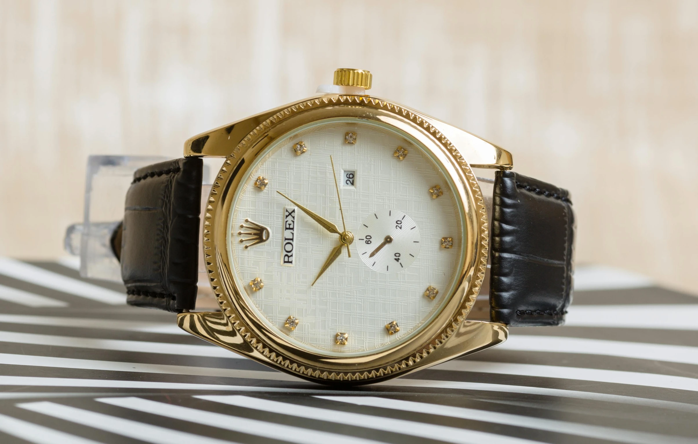 a close up of a watch on a table, inspired by Porfirio DiDonna, trending on pexels, golden pauldrons, front shot, thumbnail, beige