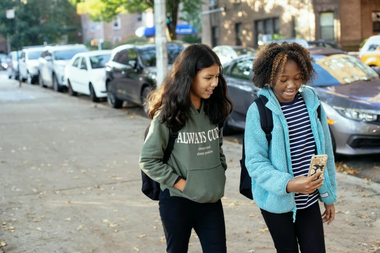 two young girls standing next to each other on a sidewalk, trending on unsplash, ashcan school, black teenage girl, background image