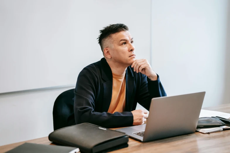 a man sitting at a table with a laptop, trending on unsplash, looking confused, cliff chiang, sitting in the classroom, profile image