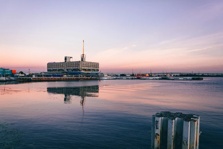 a large boat sitting on top of a body of water, by Lee Loughridge, pexels contest winner, city docks, magic hour, terminal, clear photo