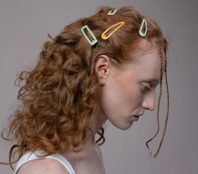 a woman with a pair of hair clips in her hair, trending on pexels, renaissance, ginger wavy hair, pastel colours overlap, made of paperclips, overcast mood