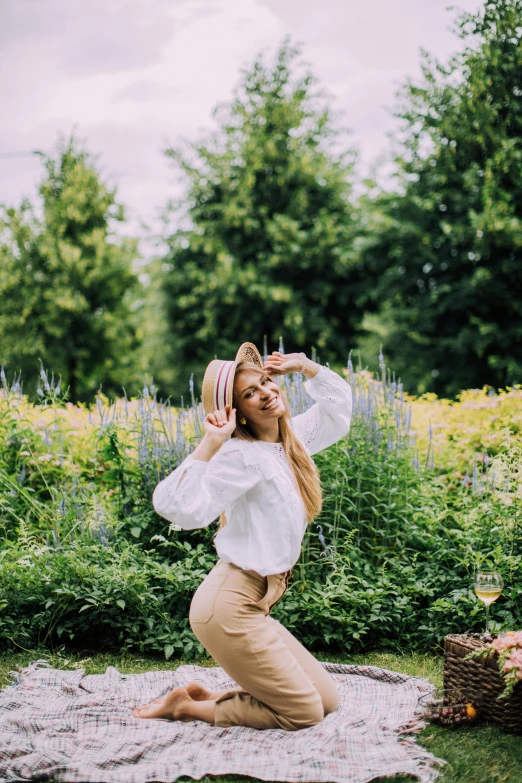 a woman sitting on a blanket in a field, by Julia Pishtar, trending on pexels, renaissance, standing in a botanical garden, doing a sassy pose, wearing a white blouse, panoramic centered view of girl