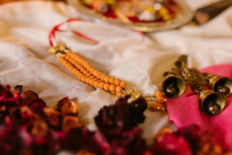 a close up of a plate of food on a table, by Julia Pishtar, unsplash, hurufiyya, hindu ornaments, beads, wedding, brown