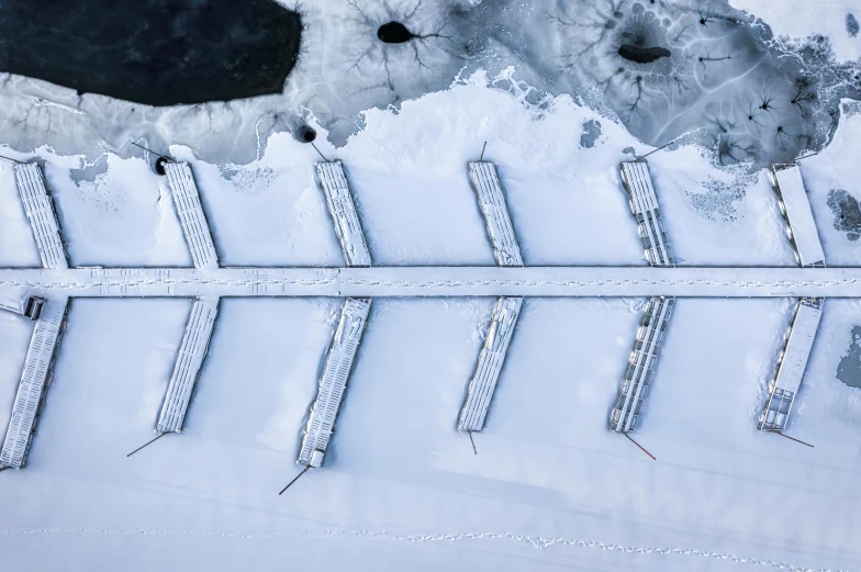 an aerial view of a parking lot covered in snow, inspired by Einar Hakonarson, pexels contest winner, land art, boat dock, thumbnail, ice arrows, white