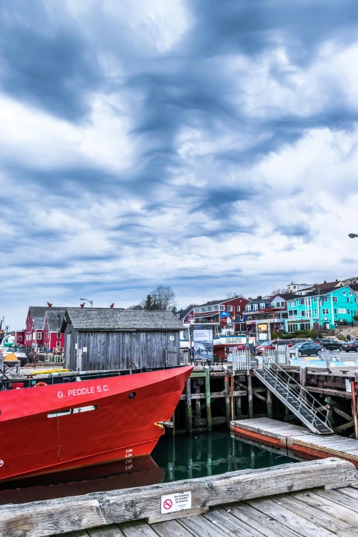 a red boat sitting on top of a wooden dock, colorful houses, broadway, profile image, 2019 trending photo