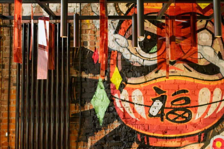 a mural on the side of a brick building, unsplash, asian interior decoration, chinatown bar, avatar image, wind chimes