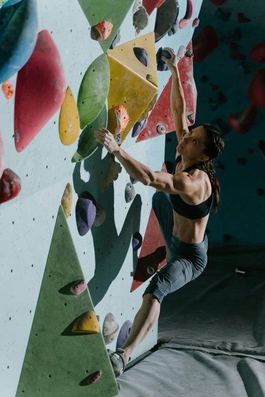 a woman climbing on a rock wall in a gym, a portrait, pexels contest winner, renaissance, promo image, manuka, adam ondra, highly upvoted