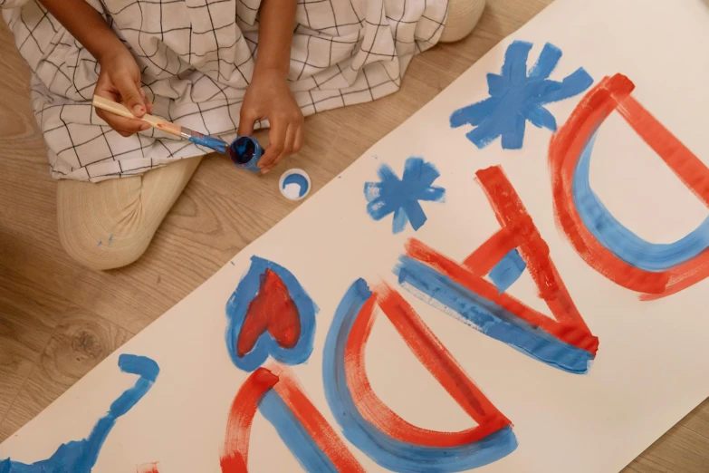 a child is painting the word dad on a piece of paper, inspired by Henri Matisse, pexels contest winner, action painting, red and blue garments, on a canva, indi creates, teaser