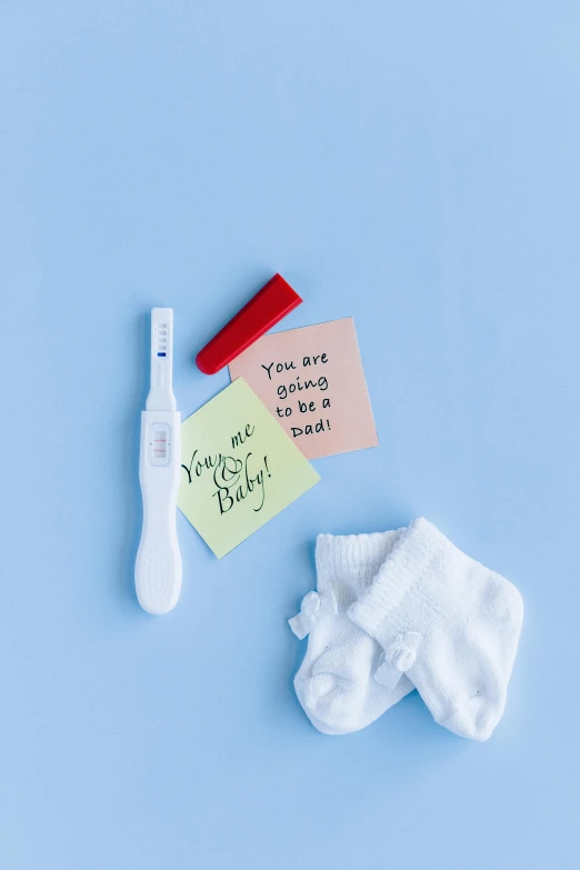 a toothbrush, toothpaste, and sticky notes on a blue surface, happening, pregnant, jen atkin, so cute, high key