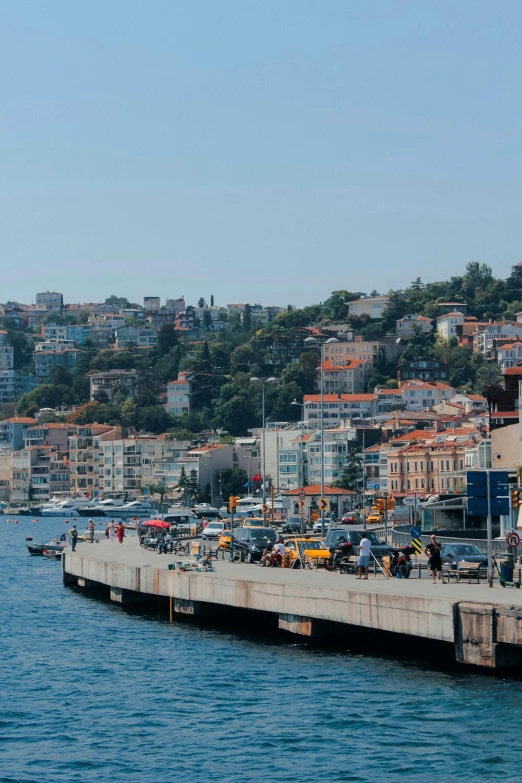 a large body of water filled with lots of boats, by Niyazi Selimoglu, waterfront houses, slide show, istanbul, hills in the background