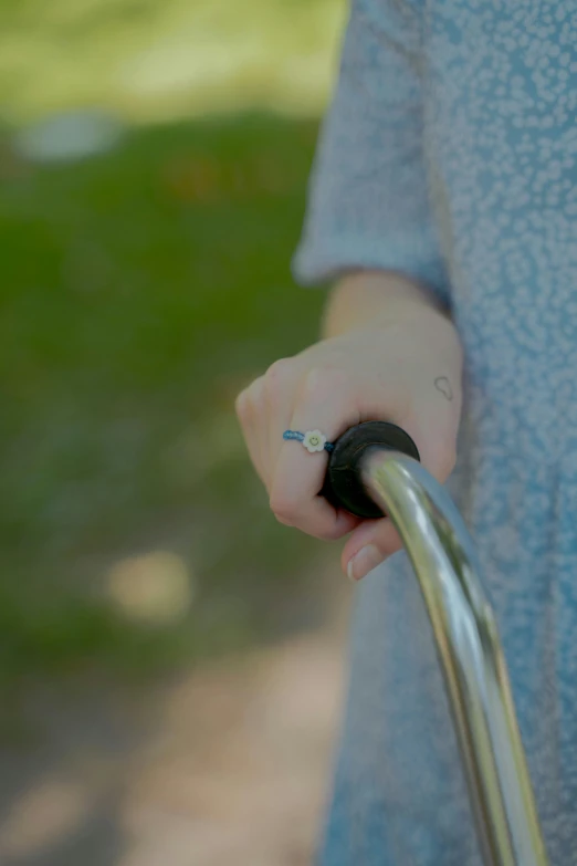 a close up of a person holding a bike handle, happening, holding walking stick, extended clip, transparent